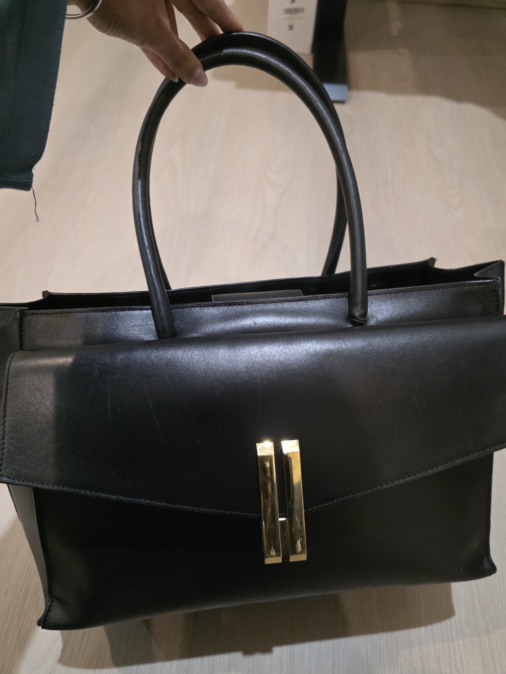 Demellier Structured Black Leather Top-Handle Bag with Gold Hardware